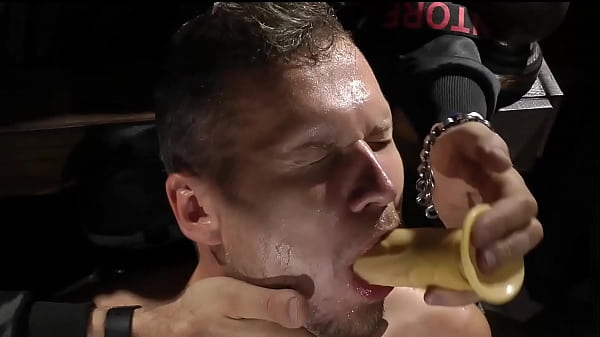 sub on chair with dildo in mouth